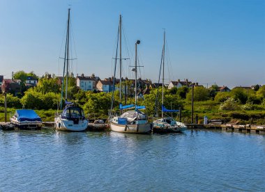 Güneşli bir öğleden sonra, Kent, Faversham yakınlarındaki bir dereye demirlemiş tekneler.