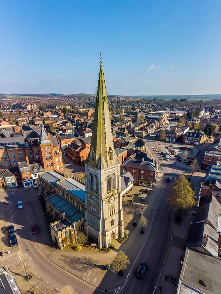 A panorama aerial view looking down the High Street and across the central square in the town of Market Harborough, UK in springtime