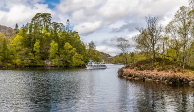 A view out into Loch Katrine in the Scottish Highlands on a summers day clipart