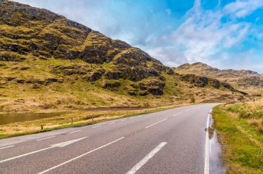 A view of the road beside Loch Restil in the Arrochar Alps, Scotland on a summers day