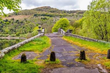 A view towards an old bridge on the outskirts of Inveraray, Scotland on a summers day clipart