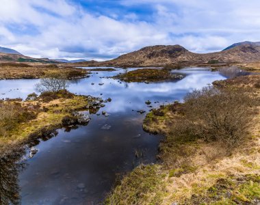 Glencoe, İskoçya yakınlarındaki bir derede beslenen bir göl manzarası