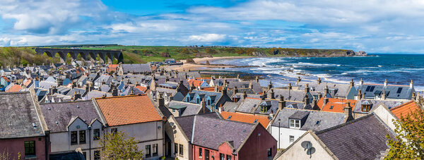 A panorama view across the roof tops and beach at the town of  Cullen, Scotland on a summers day
