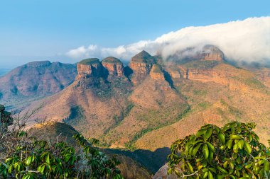 A view over bushes on the rim of Blyde River Canyon towards the three Rondavels,  Mpumalanga, South Africa in Springtime