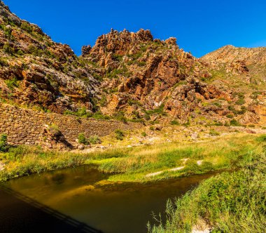 Cogman Nehri 'nin karşısındaki Langeberg dağ sırasındaki Cogmans Kloof vadisinde ilkbaharda Güney Afrika' da Ashton yakınlarında bir manzara.