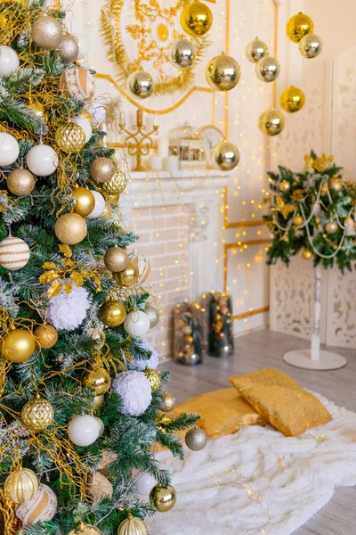 new year\'s interior of the house in gold color, Christmas tree with balloons and garland