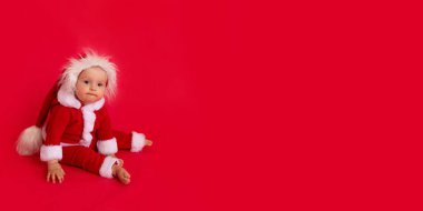 Kırmızı arka planda Noel Baba kostümlü bir çocuk, afiş, mesaj için yer