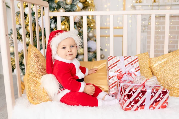 Child Santa Costume Gift Christmas Tree Golden Decor Sitting Crib — Stock Photo, Image