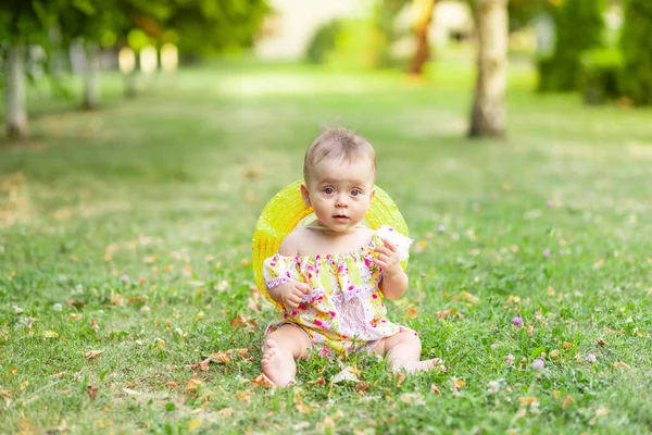 Small Baby Girl Sitting Green Grass Yellow Dress Hat Holding — Stock Photo, Image