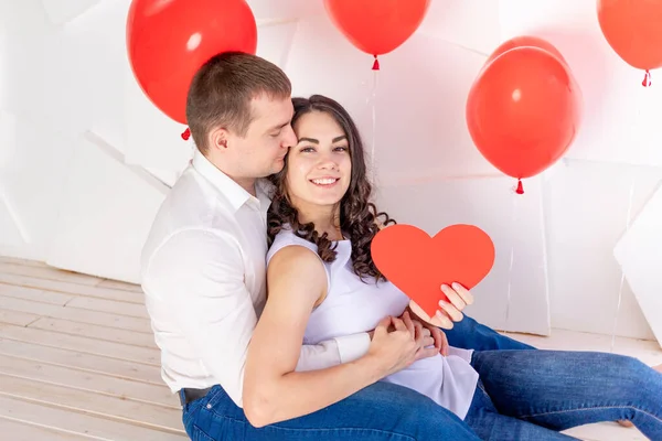 Valentine Day Guy Kisses Beautiful Girl Who Holding Big Red — Stock Photo, Image