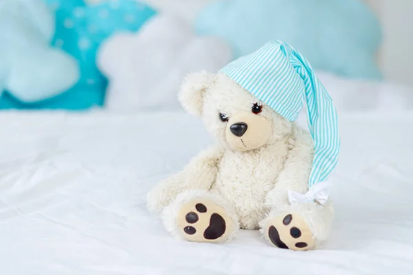 teddy bear on the bed for sleeping, the interior of the children\'s room, the concept of children\'s toys