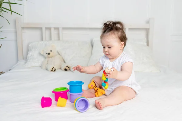 Baby Girl White Bodysuit Plays Colorful Toys Bed Home Bright — Stock Photo, Image