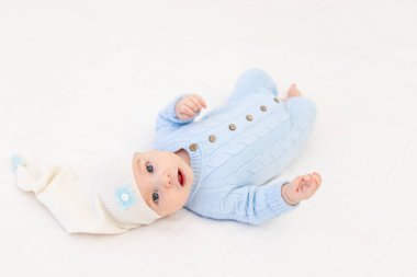 Bebek bulut yastıklarının arasında, yatakta. Çocuklar için tekstil ve yatak.