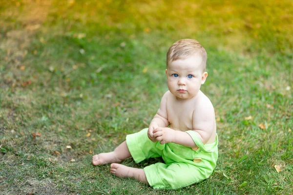 Милий Хлопчик Сидить Зеленому Газоні Влітку Великими Блакитними Очима Місце — стокове фото