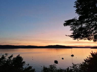 Gölün üzerinde gün batımı Küçük tekneler ve güzel renkler