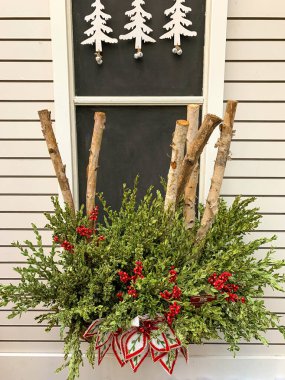 Window flower box outdoor holiday decorations. Vertical photo clipart