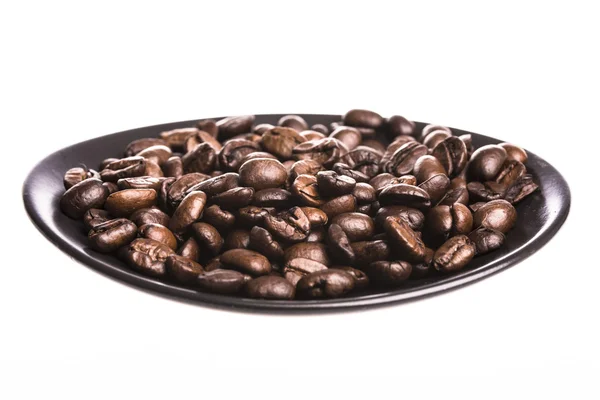 Кофейные зерна в тарелке — стоковое фото