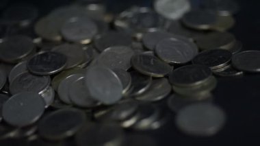 Yavaş çekimde paralar karanlığa düşüyor..