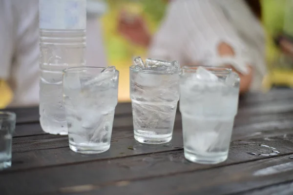 Group Glass of ice on wood table.