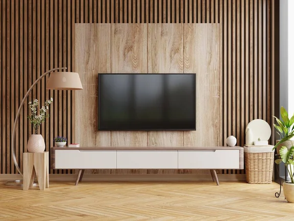 Mockup a TV wall mounted in a dark room with a dark wood wall.3d rendering