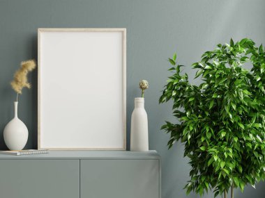 Koyu yeşil dolapta, üzerinde güzel bitkiler olan bir fotoğraf çerçevesi.