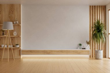 Modern oturma odasının içinde ahşap bir televizyon duvarı ünitesi, iç mekan bitkisi, yumuşak doğal ışık, yer lambası ve raflarda dekoratif eşyalar var.