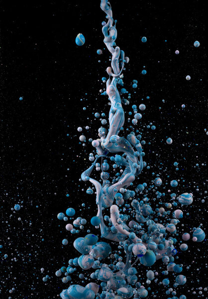 Colors in space. Bubbles rising. Colorful paint under water. Artistic abstract design isolated on black background.