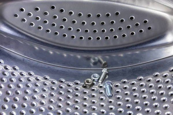 dropped out of the pockets of clothes bolts and nuts are inside the washing machine