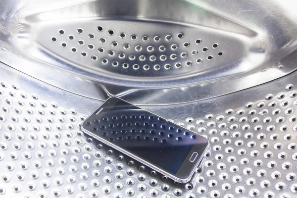 fallen from the pocket of clothes cell phone is inside the washing machine drum