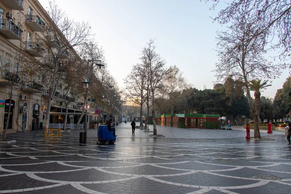 Barredora de carreteras industrial cepillando una calle de la ciudad en Bakú - Azerbaiyán: 2 de enero de 2021. Máquina de limpieza de calles en el parque. —  Fotos de Stock