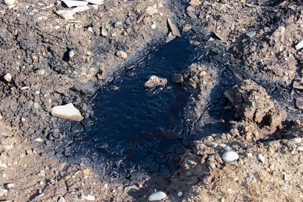 Soil polluted with oil waste. Concept of harm to environment and ecology disaster. Dirty Oil spill