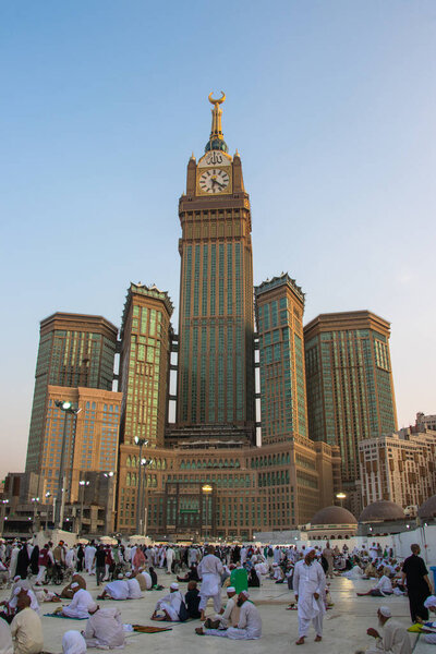 Abraj Al Bait Tower in Mecca, Saudi Arabia -August 2018. Royal Clock Tower, blue sky scenery and pilgrims from around the world