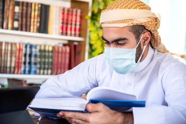 Arabic guys studying for exam together wearing protection masks