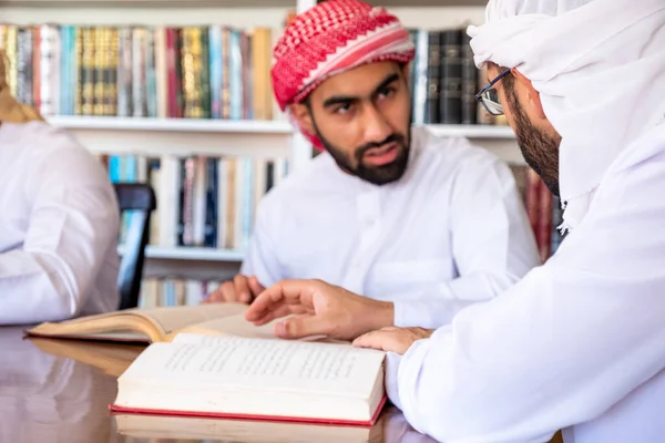 Group of arabic guys studying for exam together