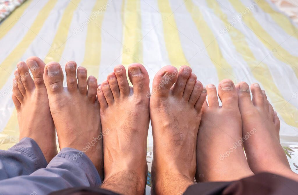 a group of epople barefoots sticking togther