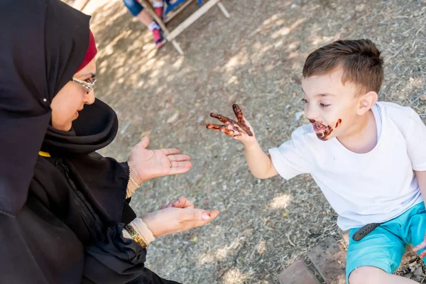 Arabic mother get angry with her son cause s he covered him self with chocolate