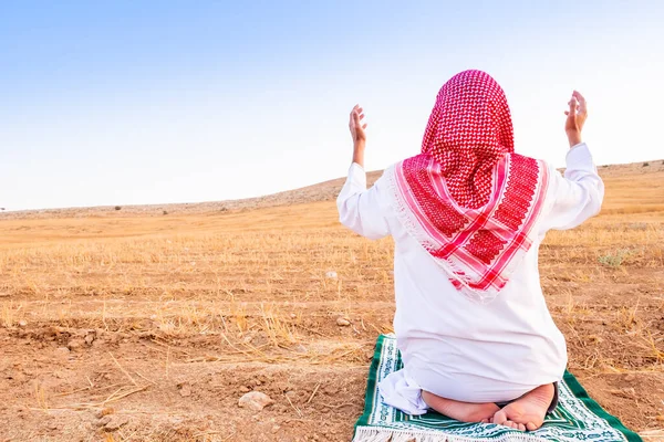 Arab people outside praying for god in the nature