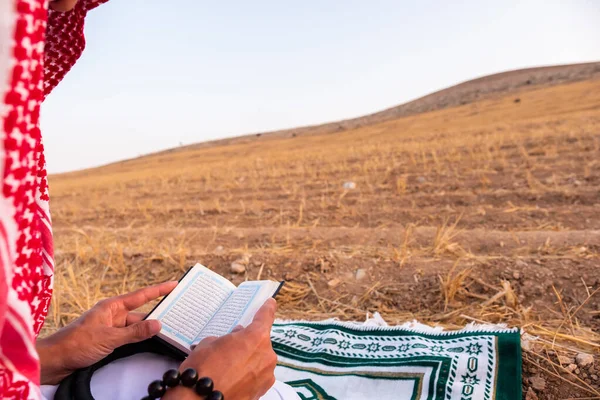 Arab people outside praying for god in the nature