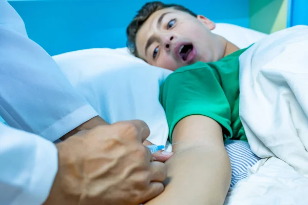 Doctor treating patient with needle