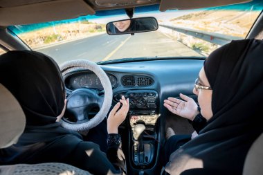 İki Arap kadın tartışırken araba kullanıyor