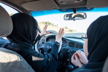 İki Arap kadın tartışırken araba kullanıyor