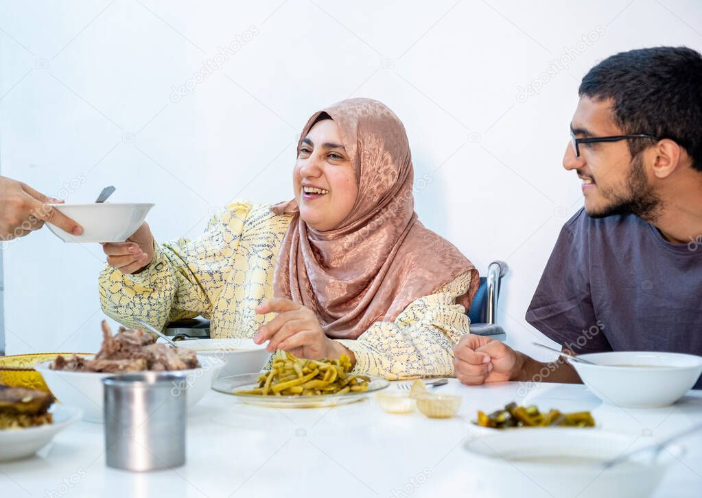 Muslim family eating their meal together