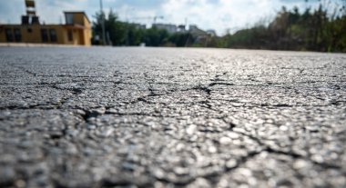 Asfalt yolu, zaman faktörleri ve bakım ve takip eksikliği nedeniyle çatlaklar ve çatlaklardan muzdarip.