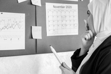 Müslüman kadınlar zaman ve görev ayarlamak için ofisteki yapışkan notları kullanıyorlar.