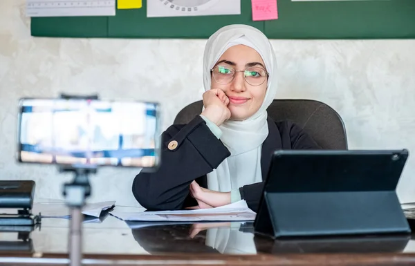 Happy muslim woman coach teacher webinar speaker looking at camera giving online class lecture or making conference video chat call, smiling businesswoman  entrepreneur recording video training, webcam view