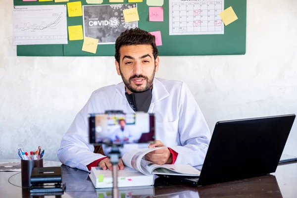 Doctotr man wearing lab coach jop interview webinar speaker looking at camera giving online class lecture or making conference video chat call, smiling businessman  entrepreneur recording video training, webcam view