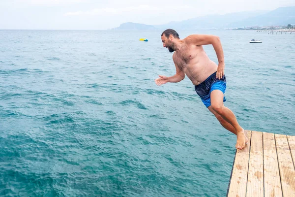 Man jumping inside the ocean
