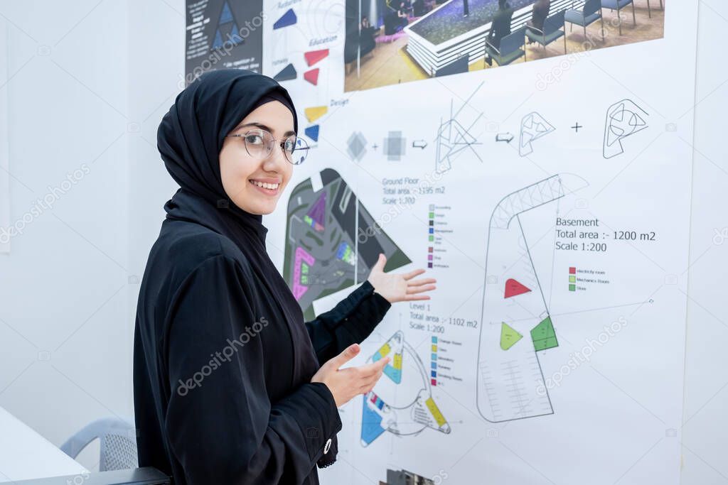 Arab female architect welcoming others to see her project