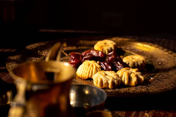 Arabic sweets, maamoul and coffee on traditional background