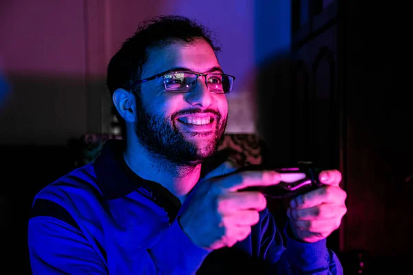 arabic guy playing console games alone